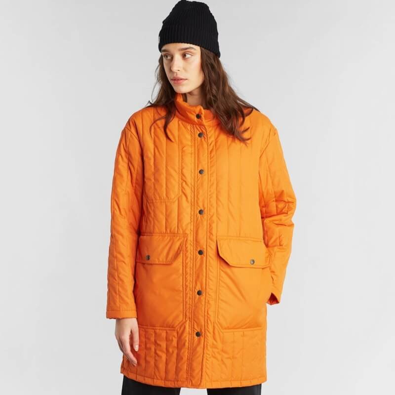 woman wearing sustainable orange coat