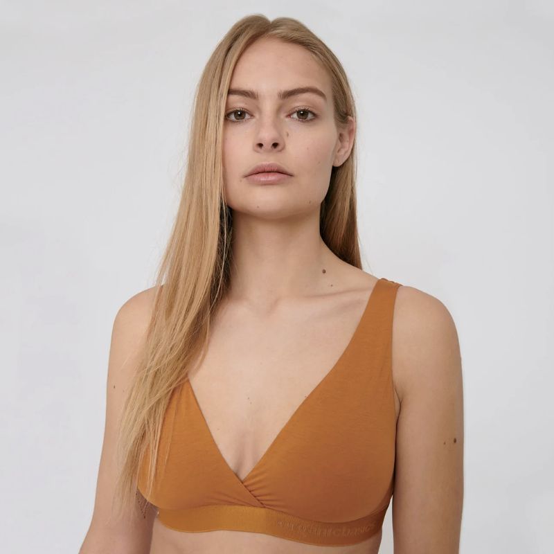 woman wearing oranged colored bralette from Organic Basics