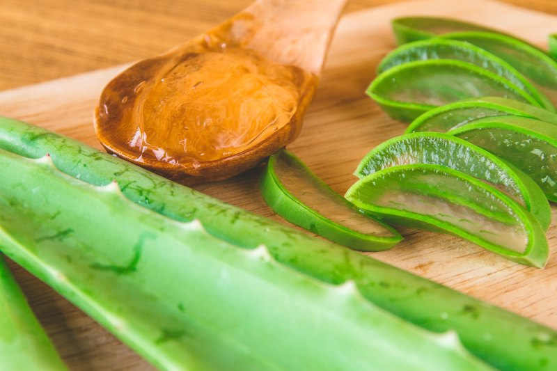 Close up of Aloe vera gel with aloe vera on wooden tray. Selective focus