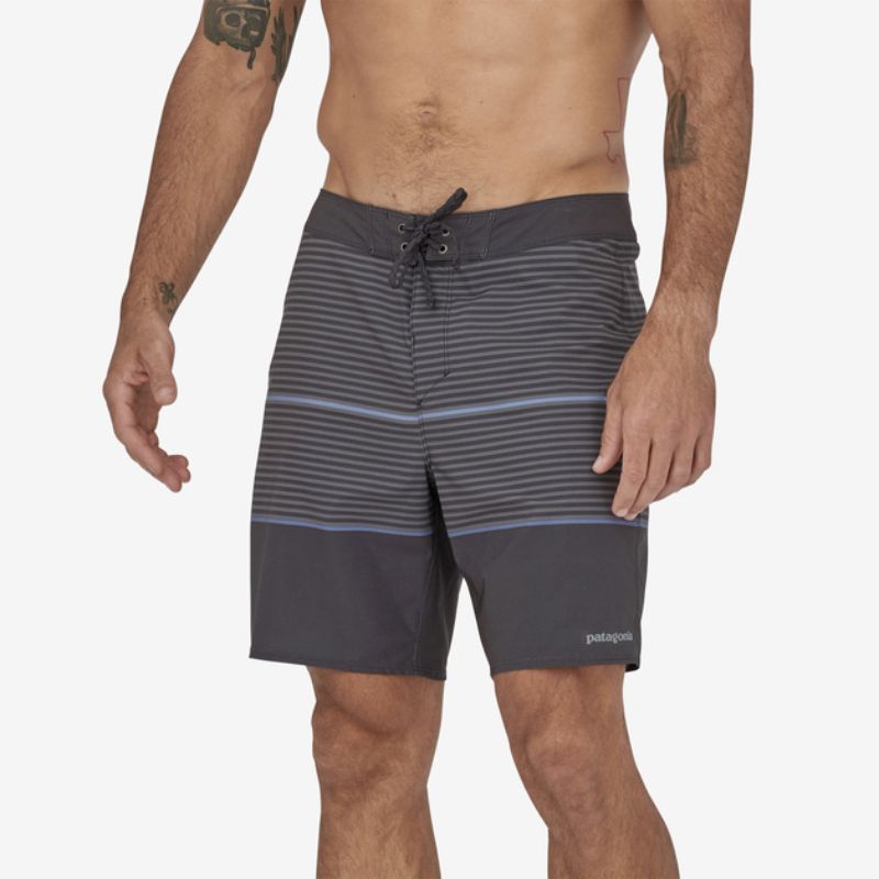 man wearing grey black sustainable swimwear