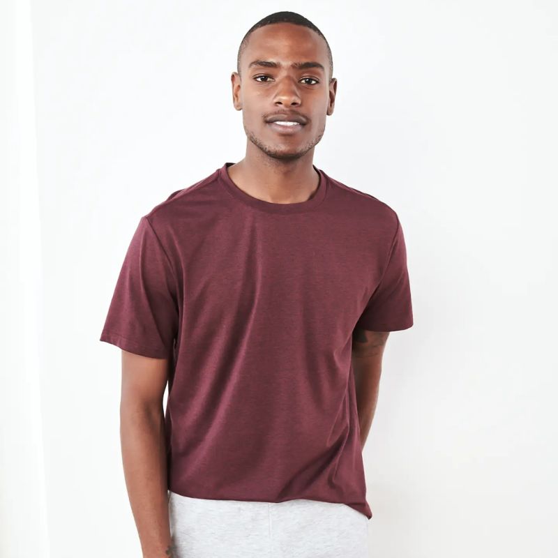 man wearing maroon colored tshirt by Quince, sustainable men's clothing brands