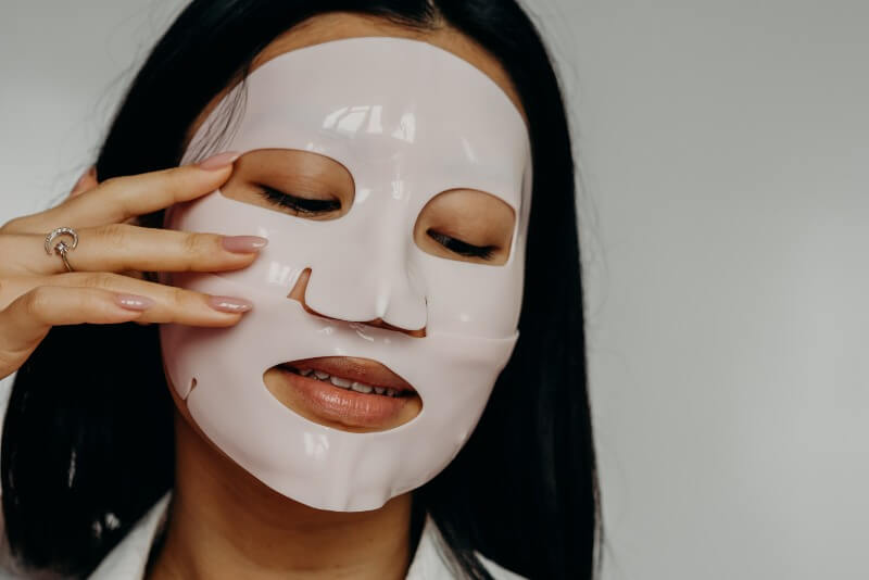 woman using face mask sheet