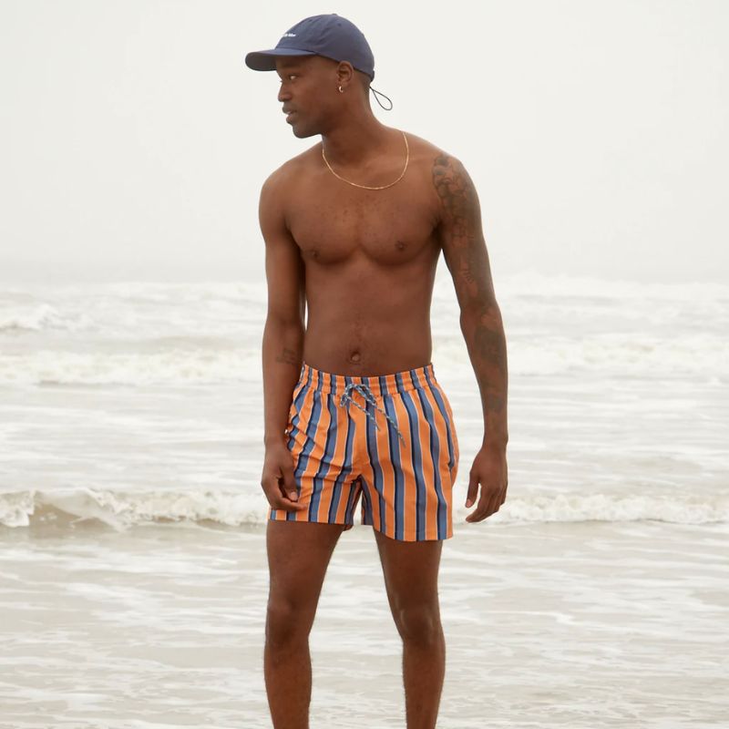 man wearing striped swim trunks